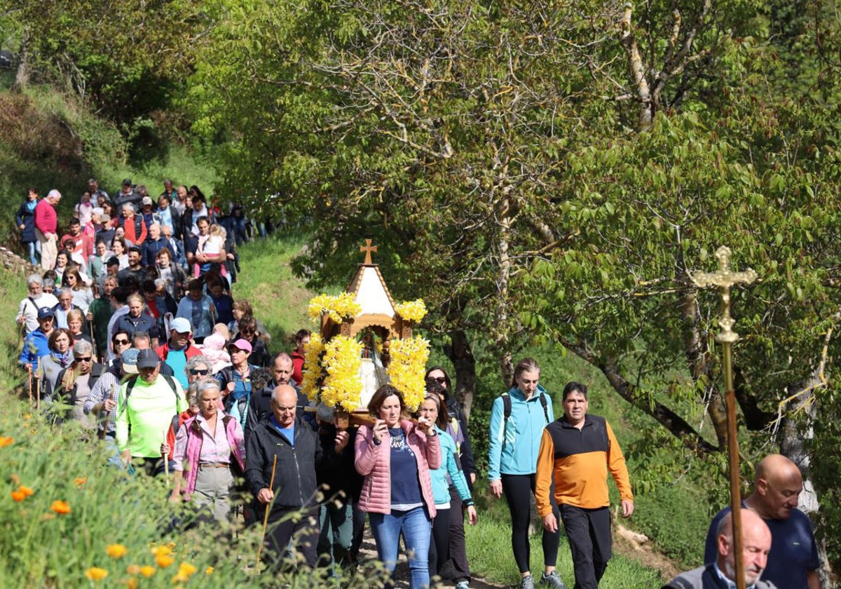 Una devota lleva en andas a la Virgen de la Luz camino de la ermita de Somaniezo