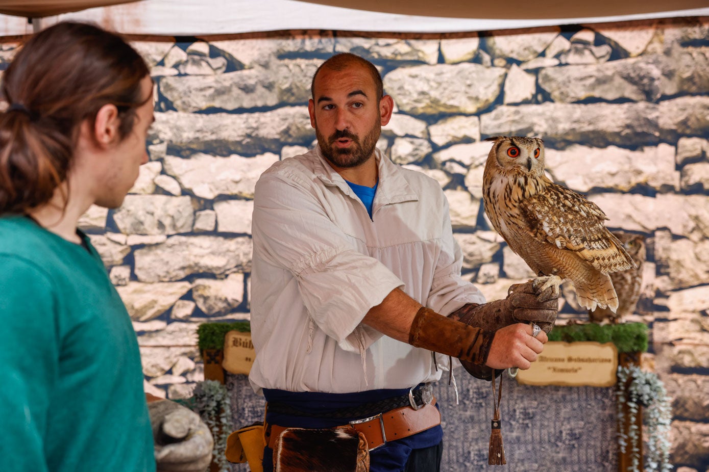 Un cetrero realiza una muestra de aves rapaces con un ejemplar de búho.