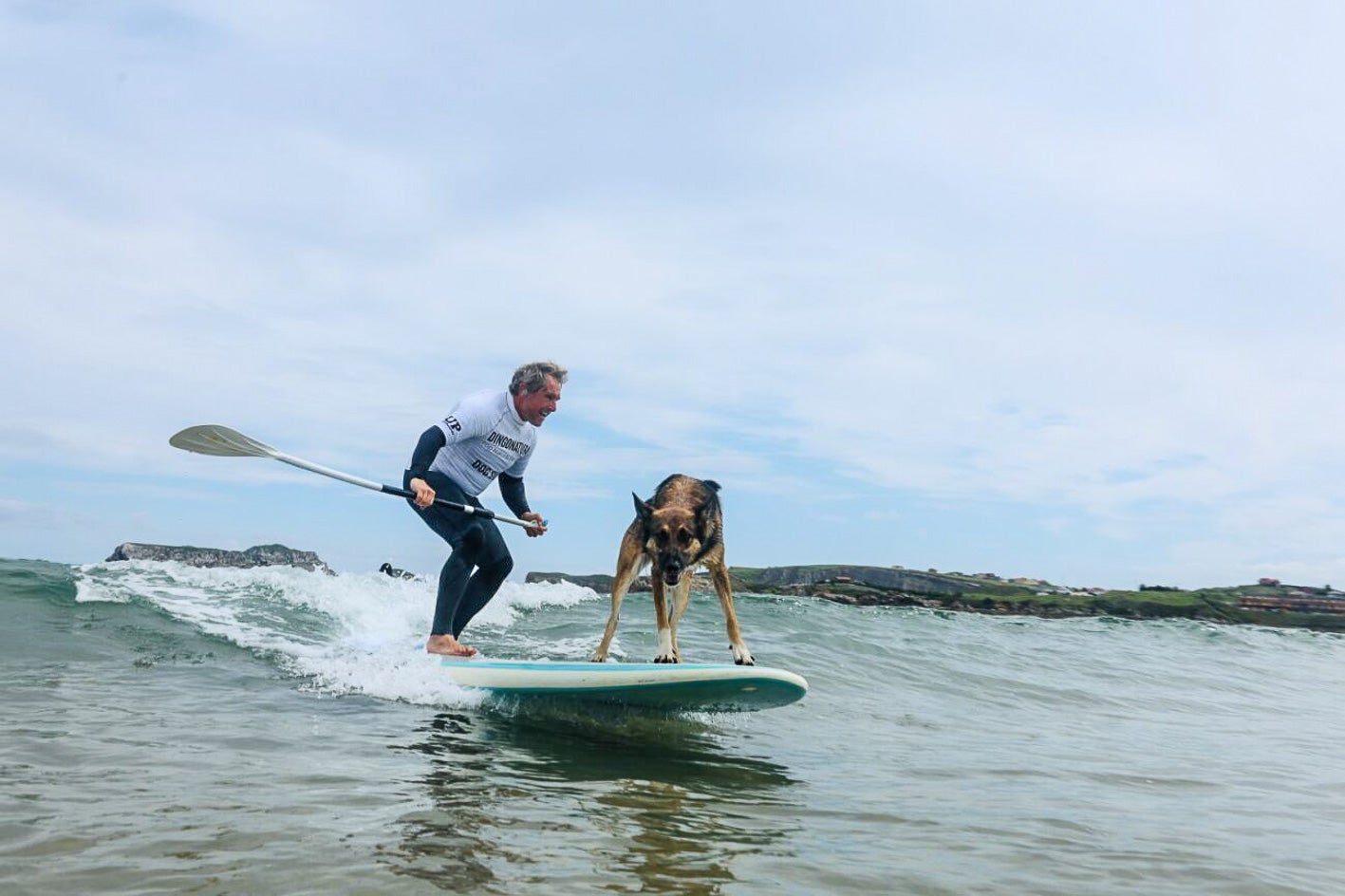 Perros y dueños cogen olas en el entrenamiento del Campeonato de Surf de Suances