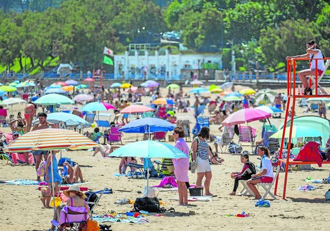 Dos vigilantes, en una de las jornadas soleadas con lleno en las playas de El Sardinero.