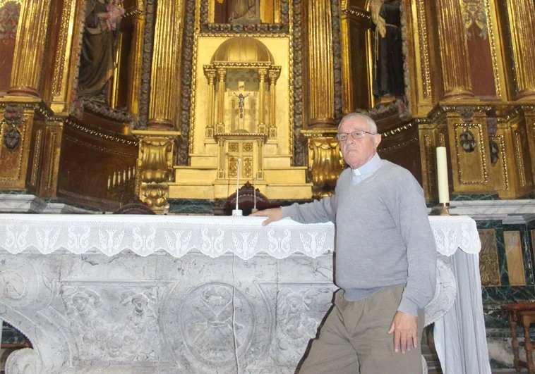 El párroco de Liérganes junto al altar y el retablo que le tiene muy preocupado.