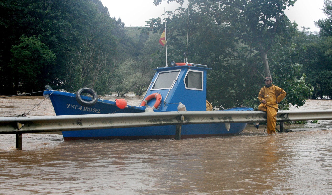 Un barco varado junto a la carretera en la zona de Unquera, donde las carreteras quedaron totalmente anegadas por el desbordamiento de los ríos tras las inundaciones de 2010.