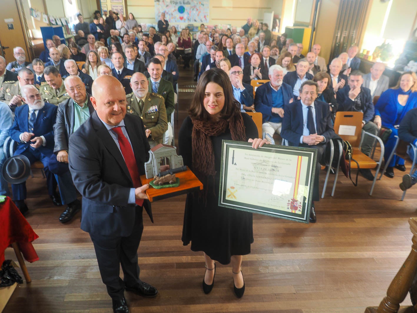 Ángel Cuadrado entrega la distinción a  Lucía Fernández, directora del Museo Marítmo del Cantábrico.