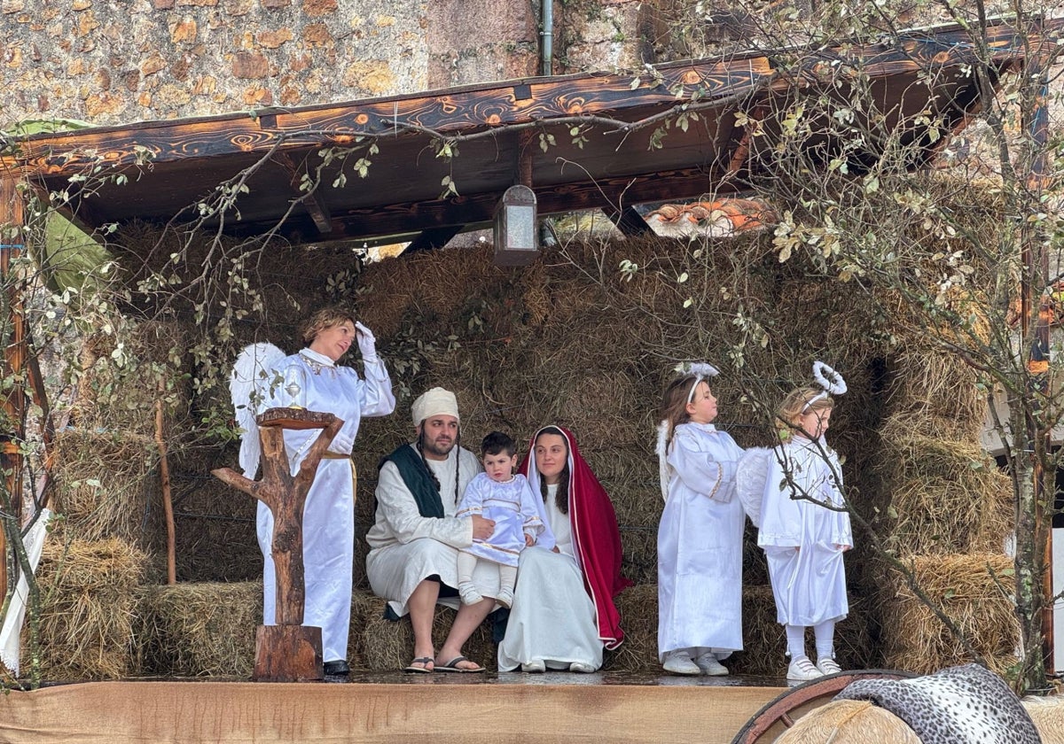 San José, la Virgen María y el niño Jesús en el pesebre acompañados por los ángeles.