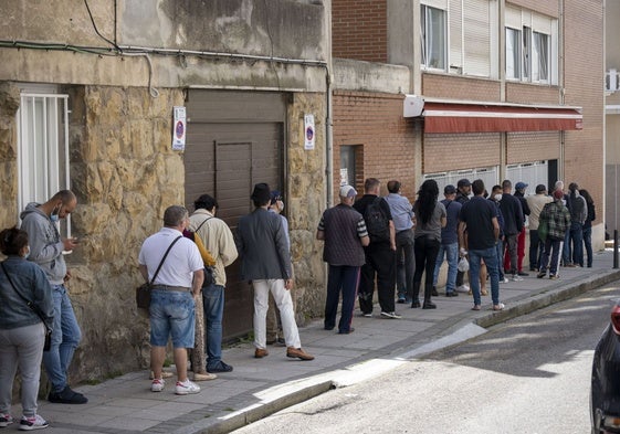 Decenas de personas hacen cola a las puertas de la Cocina Económica, en Santander.