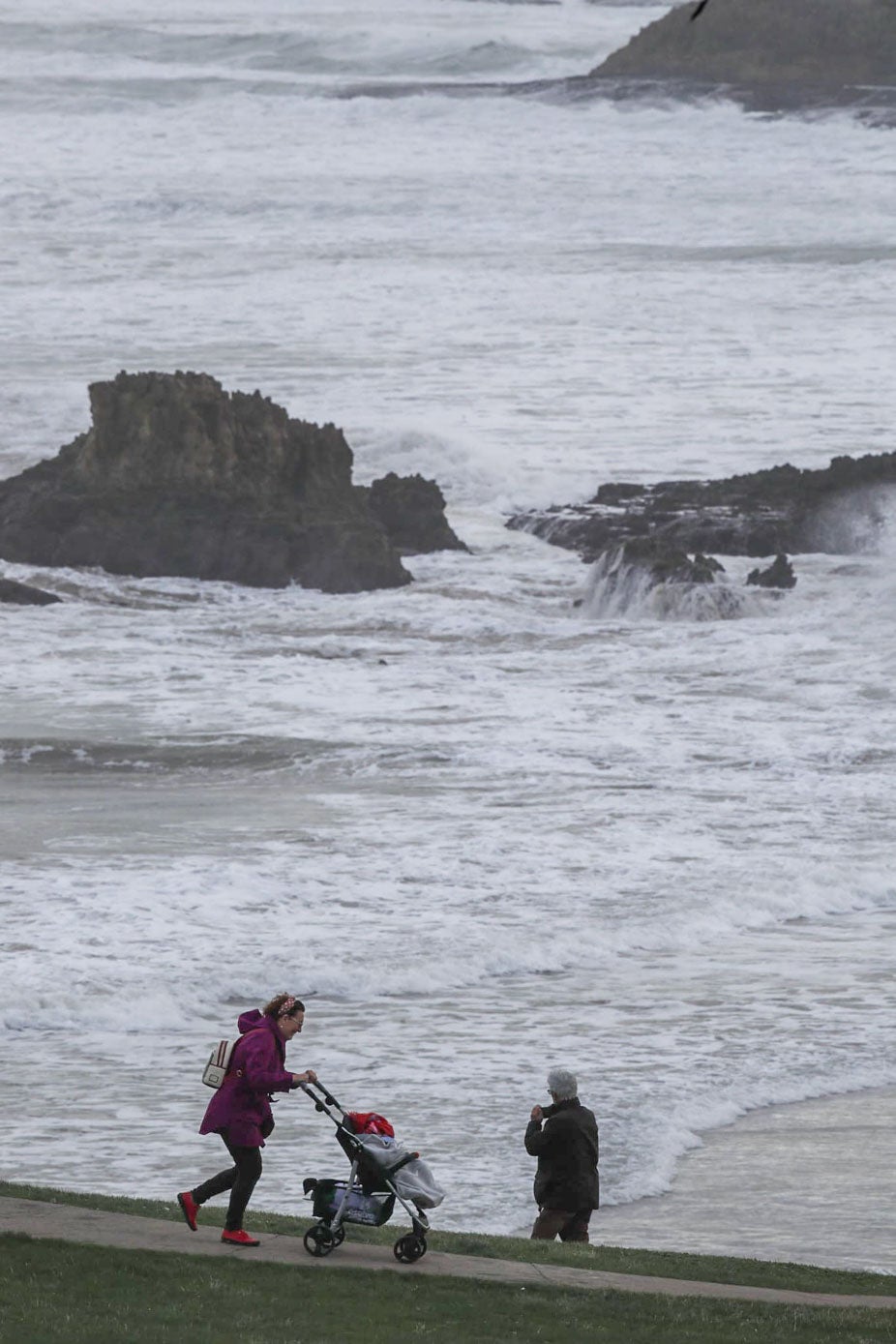 Numerosos curiosos se han acercado hoy a la costa para contemplar el oleaje.