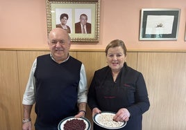 Juan y Pilar, con las alubias rojas y las alubias blancas, con los padres de ella retratados detrás.