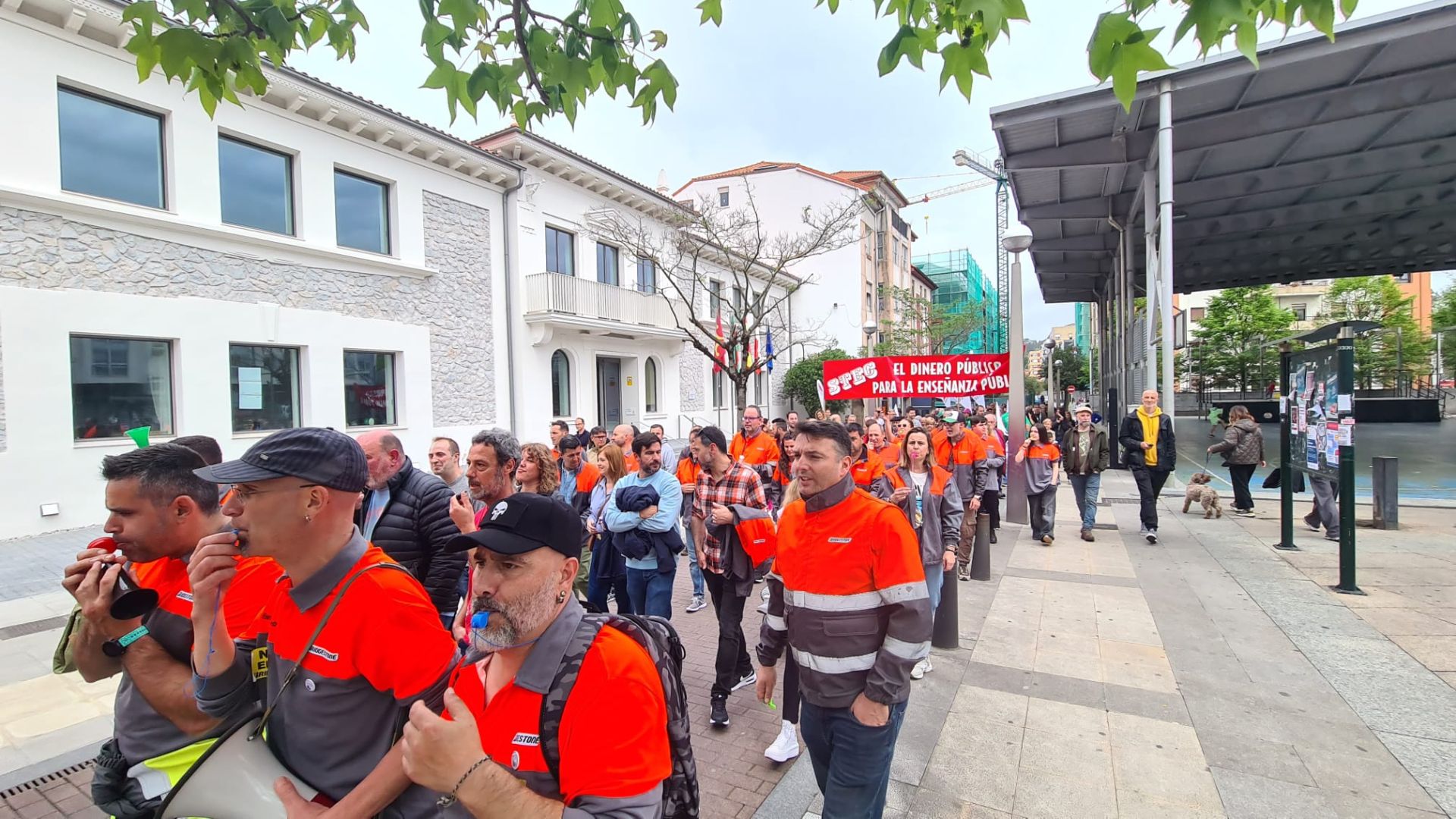 Un grupo de trabajadores de Bridgestone marcha frente a la nueva sede del Ayuntamiento en La Llama. 