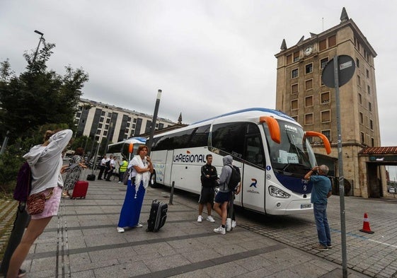 Varios usuarios esperan para subir al autobús, el verano pasado, debido al corte ferroviario que se prolongó todo agosto.