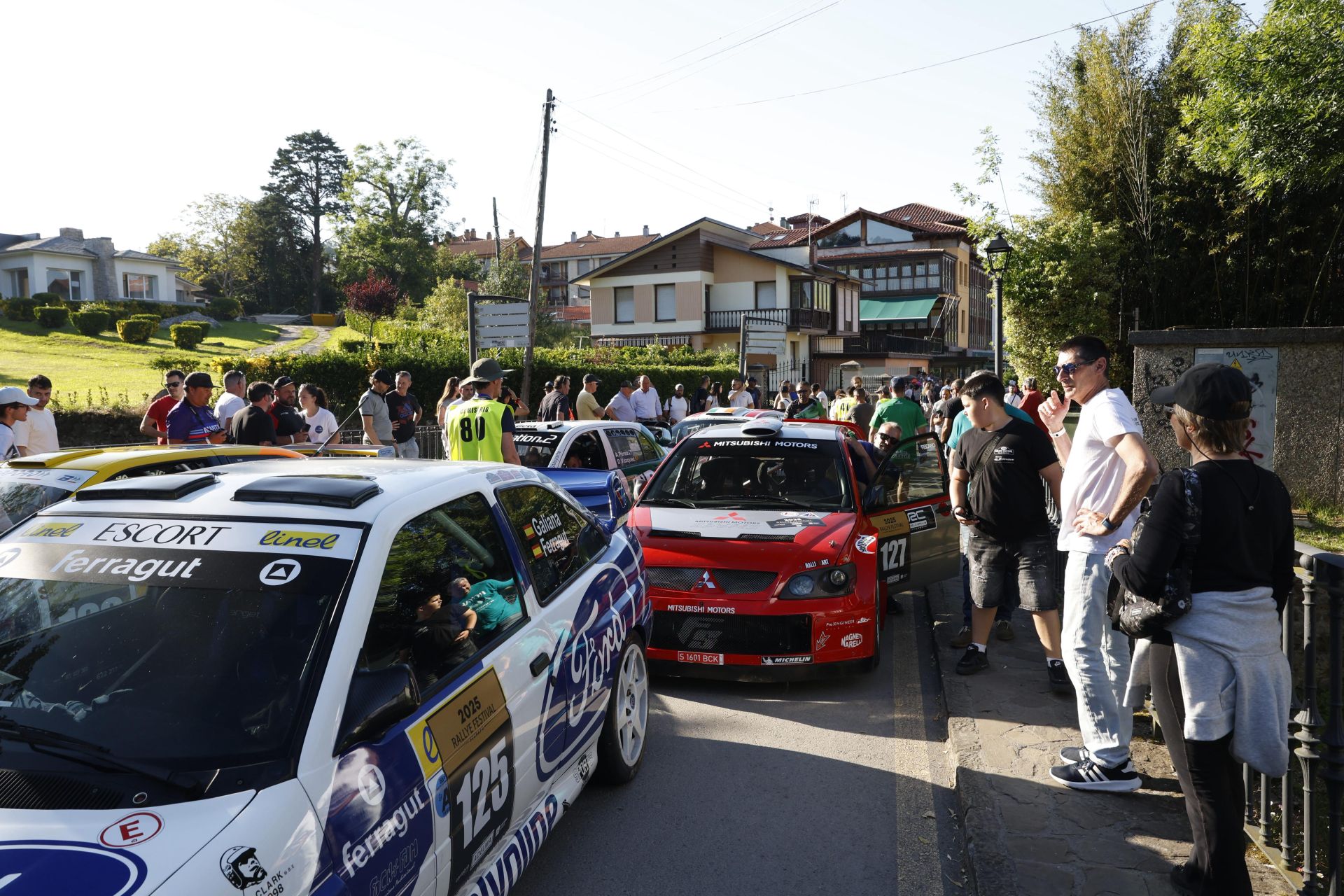 Los aficionados contemplan los coches antes de la ceremonia de salida.