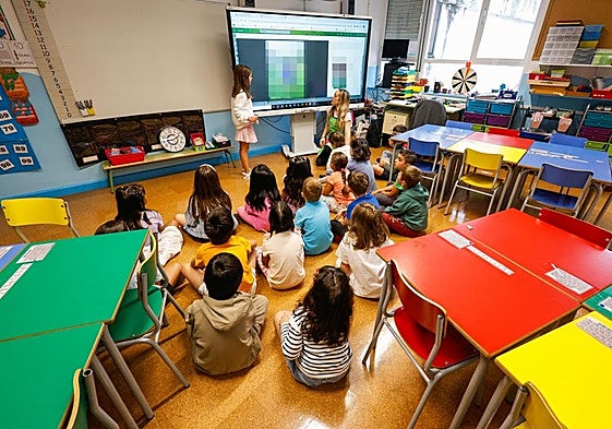 Un grupo de alumnos sentados frente a la pantalla de un aula en un centro educativo de Cantabria.