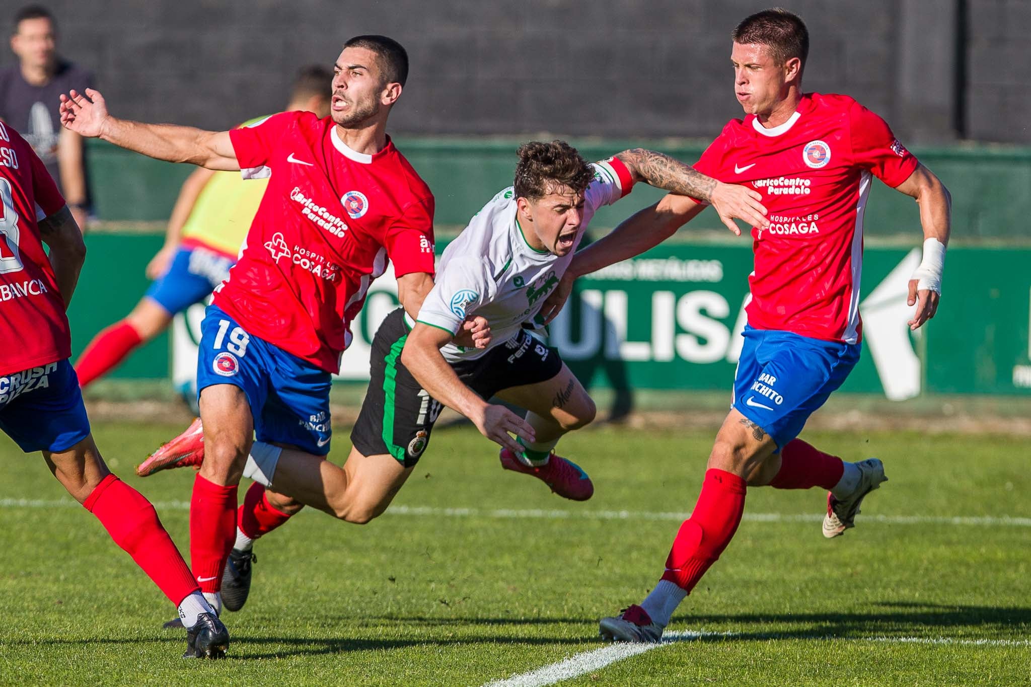 Izan, a punto de caer al suelo entre dos rivales del Ourense