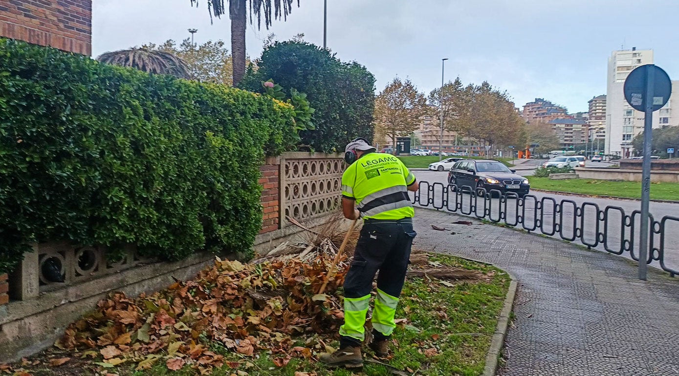 Un operario adecenta la zona tras el azote del viento en el áea de El Sardinero.