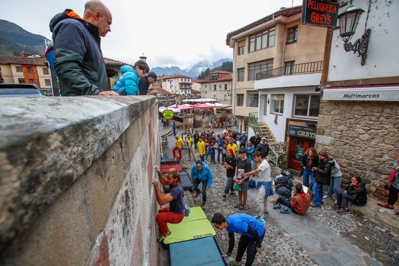 Los compañeros de grupo, pendientes del que escala y de que las colchonetas estén bien colocadas.