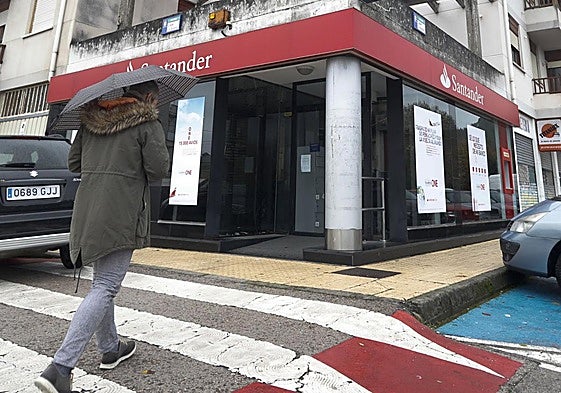 Un hombre se dirige a una oficina del Banco Santander en Barcena de Cicero.
