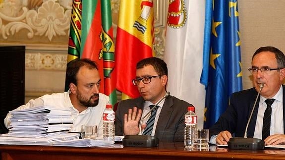 El teniente de alcalde, Javier López Estrada, conversa con el Secretario durante el último pleno, en presencia del alcalde.