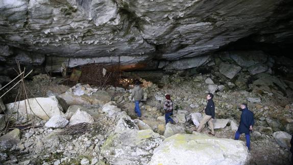 Francisco Martín, en su visita a la cueva de Sopeña (Salitre II), acompañado del alcalde, Tarsicio Gómez, y la guía Paula Miera. 