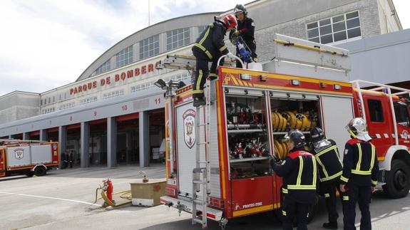 Efectivos del Parque de Bomberos de Torrelavega realizan maniobras junto a uno de los vehículos en las instalaciones junto al Ferial. 