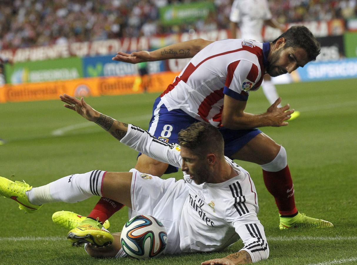 Sergio Ramos lucha un balón con Raúl García.