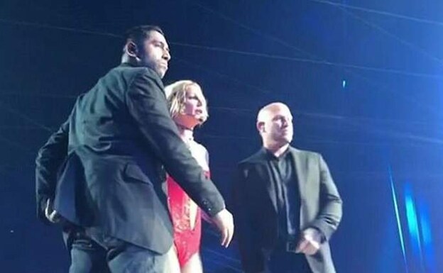 Dos guardaespaldas protegen a Britney Spears. 