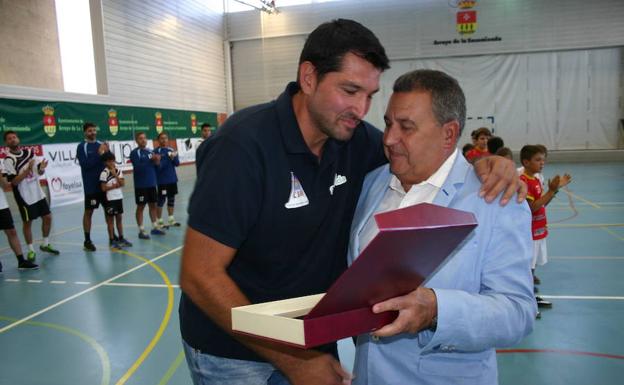Ávila recibe una placa de manos del alcalde de Arroyo. 
