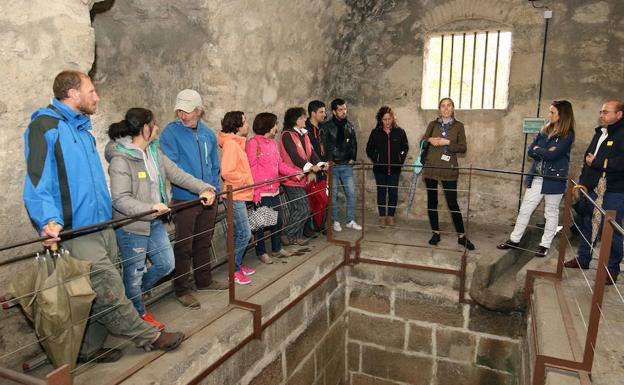 Participantes en la visita escuchan a la guía. 