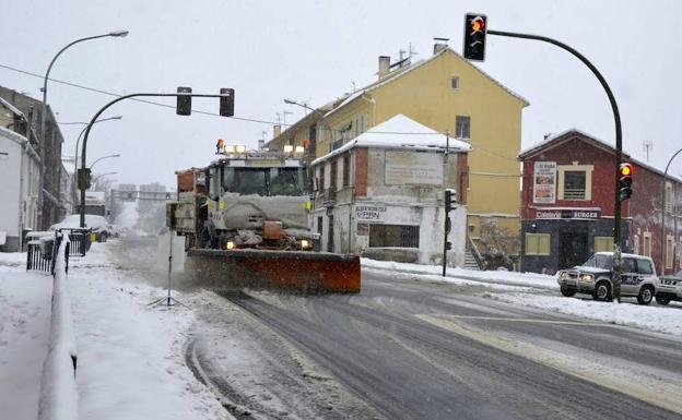 Imagen principal - Arriba, una quitanieves en la travesía de San Rafael. Abajo a la izquierda, un autobús llega al puerto de Navacerrada (CL-601), y señal de uso de cadenas en San rafael.
