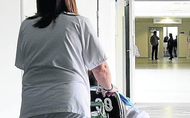 Una enfermera acompaña a un paciente en el Hospital General. 