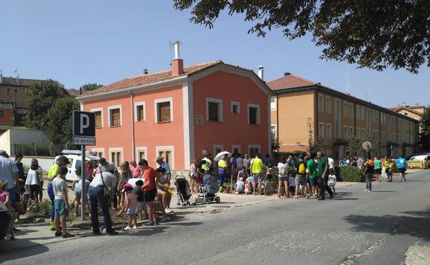 Grupos de niños participan en la plantación de rosas en pareterres de una calle de La Granja. 