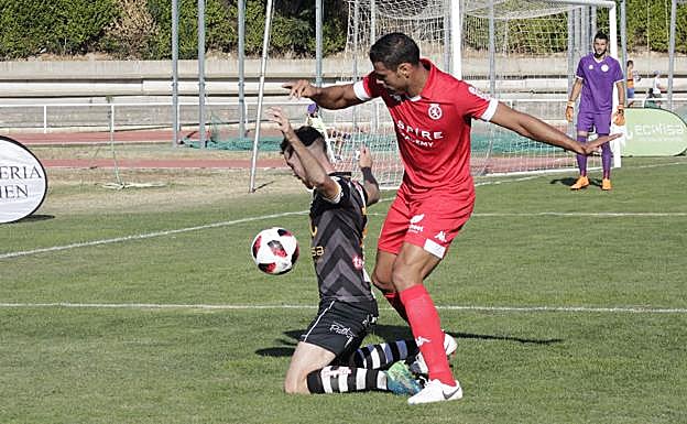 Góngora protege un balón en el suelo ante un rival de la Cultural. 