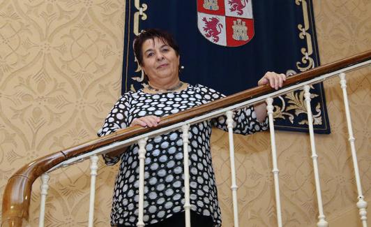 Clara Luquero posa en las escaleras de la Casa Consistorial junto al tapiz con el escudo de Castilla y León. 