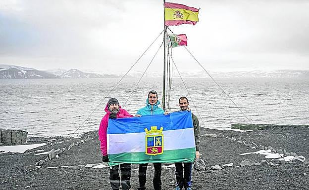 Miguel Ángel de Pablos, Pablo Tejedo y Alberto Luquero muestran la bandera del municipio de El Espinar en la Antártida. 
