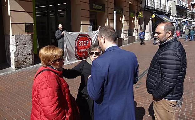 Rosa (izquierda) conversa con un directivo de Bankia en Teresa Gil.