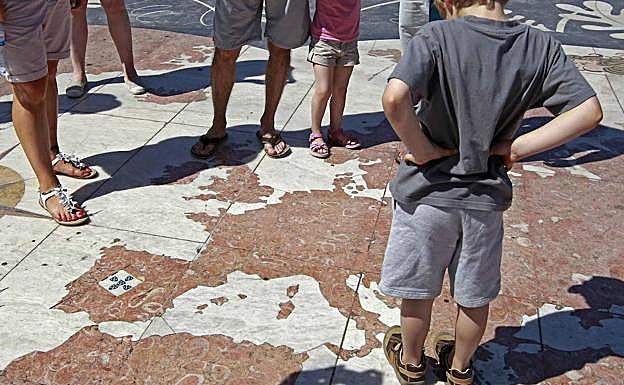 Niños contemplan el mapa de Europa trazado en el suelo de mármol, en una plaza de Lisboa. 