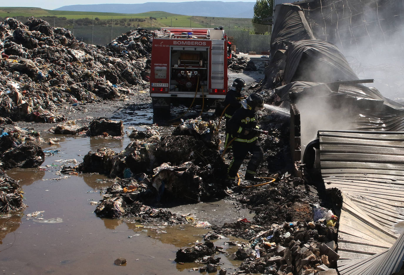 Los bomberos aún actuaban a primera hora de la mañana en los restos del incendio de la nave. 