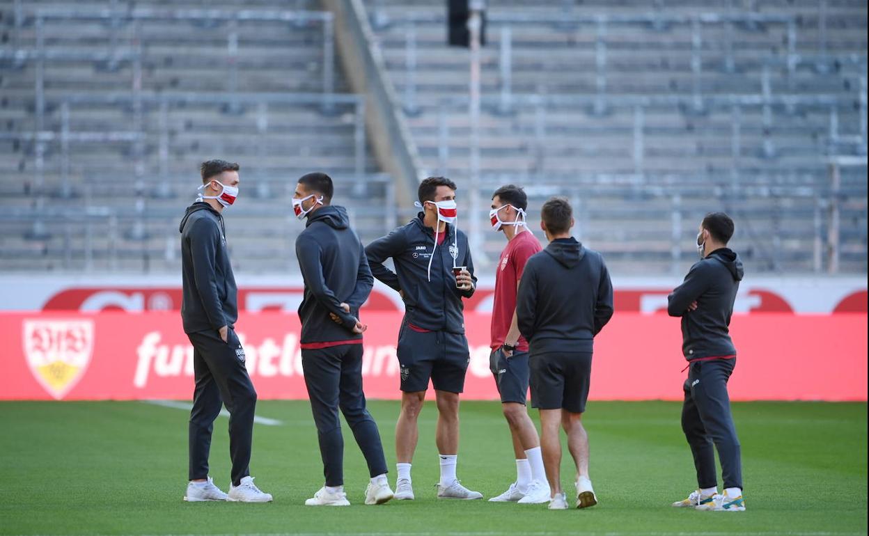 Jugadores del Stuttgart charlan en el centro del campo antes de un partido de la Segunda alemana. 