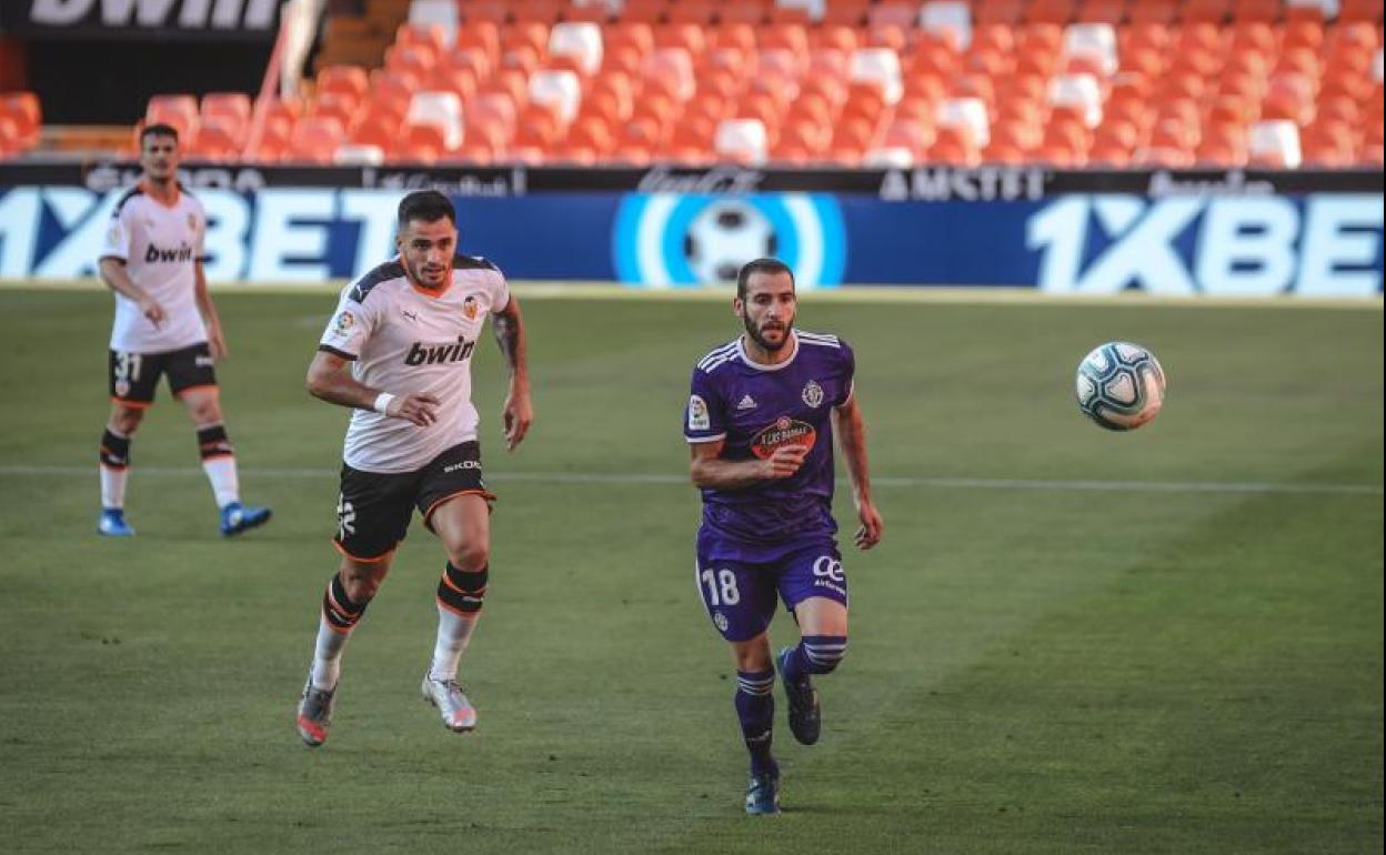 Antoñito persigue el balón por delante de Maxi Gómez en el partido del martes en Valencia. 