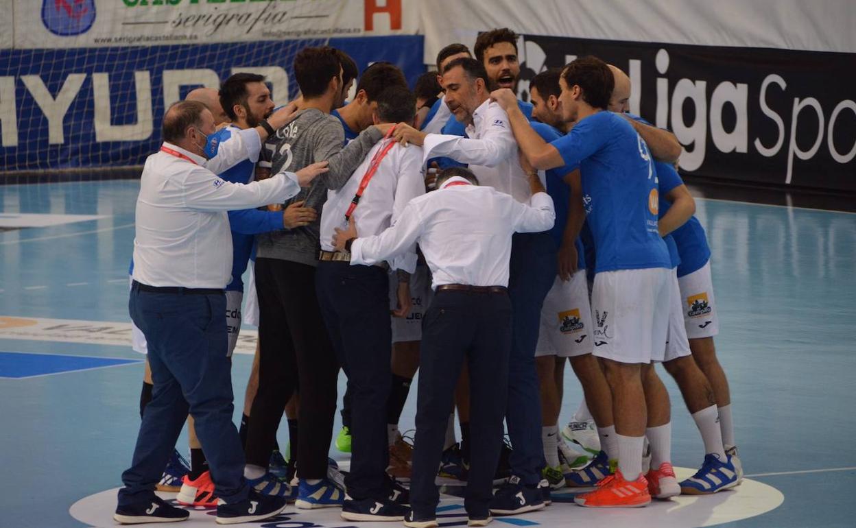 Jugadores y técnicos del Recoletas hacen piña en la pista antes de lanzar su grito. 