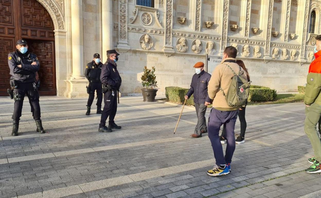 Policías vigilan el acceso a San Marcos en presencia de un grupo de empresarios de la hostelería.