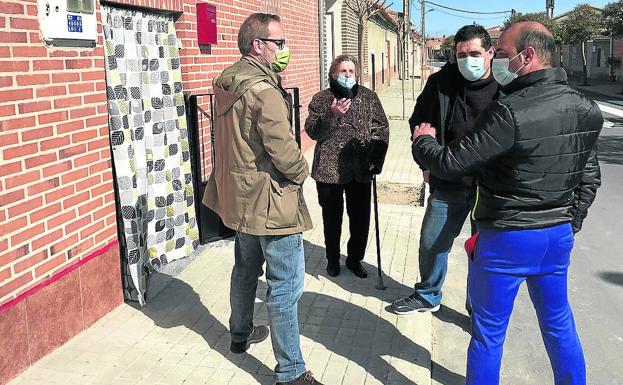 Teresa Pérez y su hijo Carlos, junto al juez de paz y el alcalde antes de entrar en casa del fallecido. .