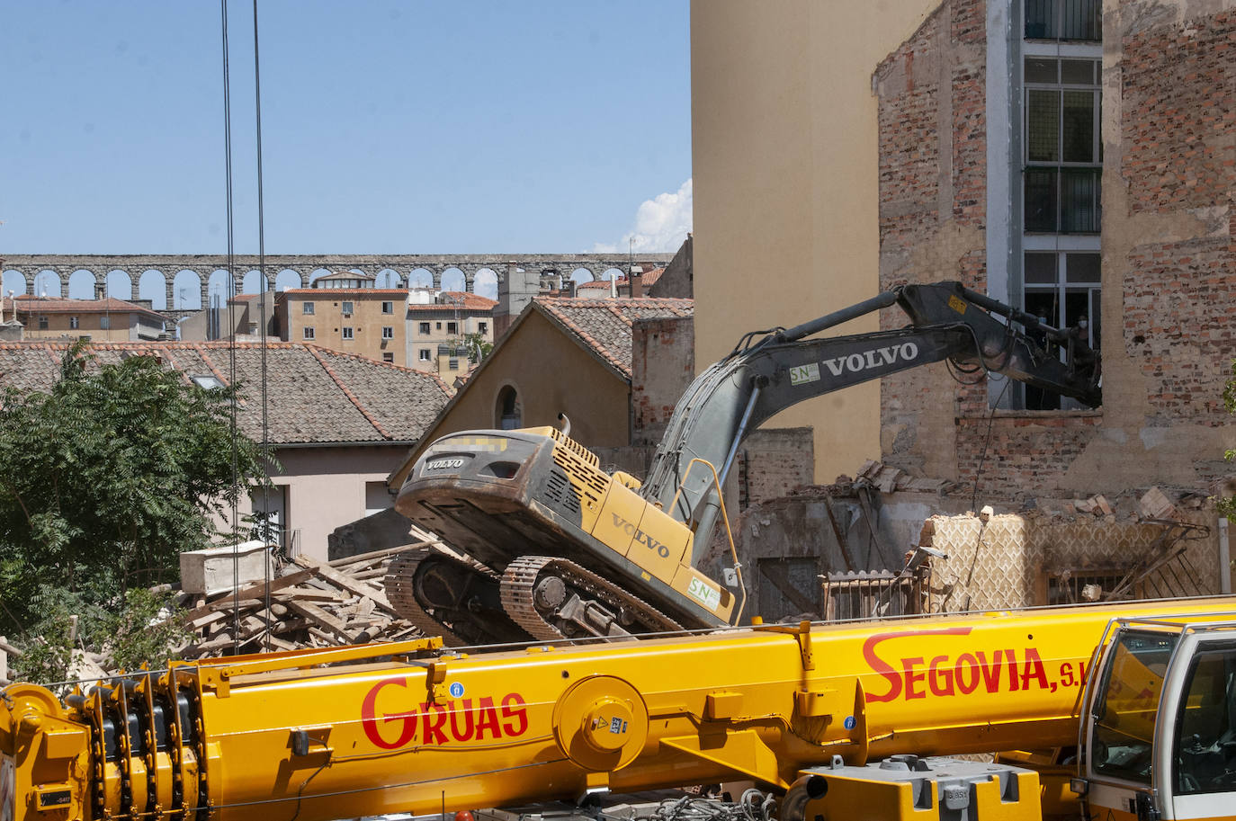 Fotos: Una excavadora en plena demolición se empotra contra un edificio en Segovia