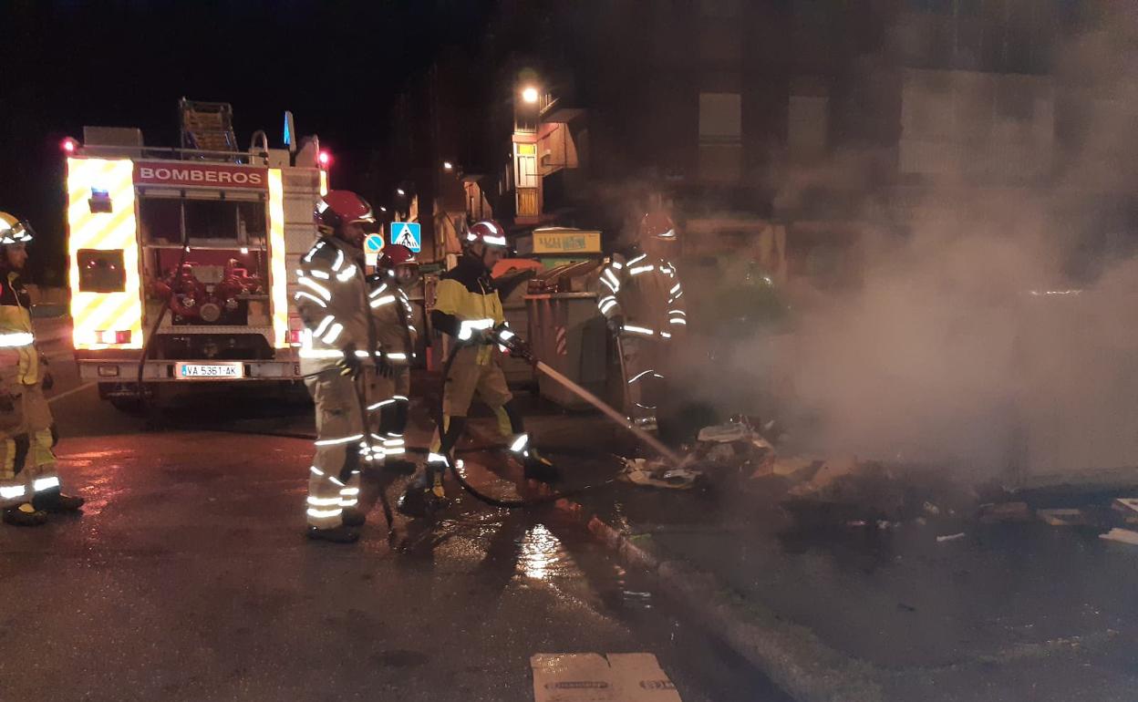 Los bomberos, durante la extinción del incendio del contenedor.