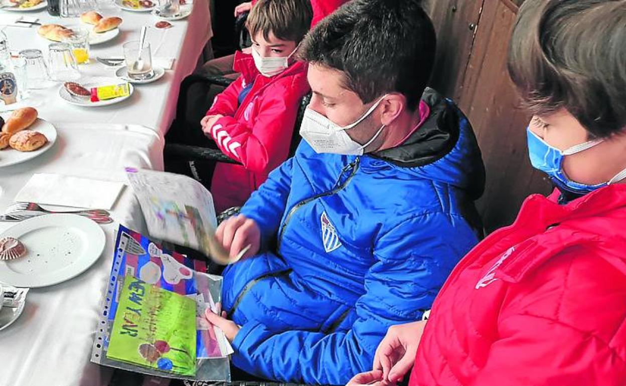 El jugador Manu viendo una de las postales. 