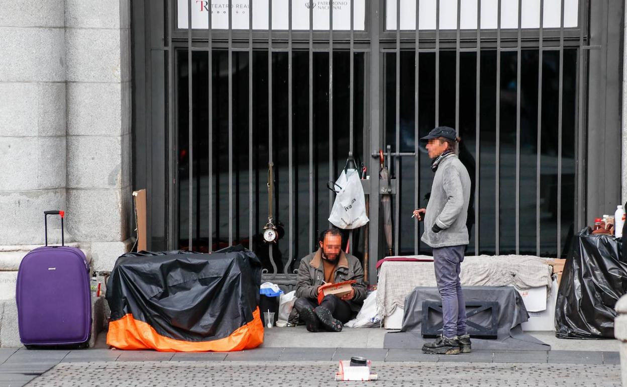 Dos hombres sin hogar en una calle de Madrid el año pasado durante el estado de alarma.