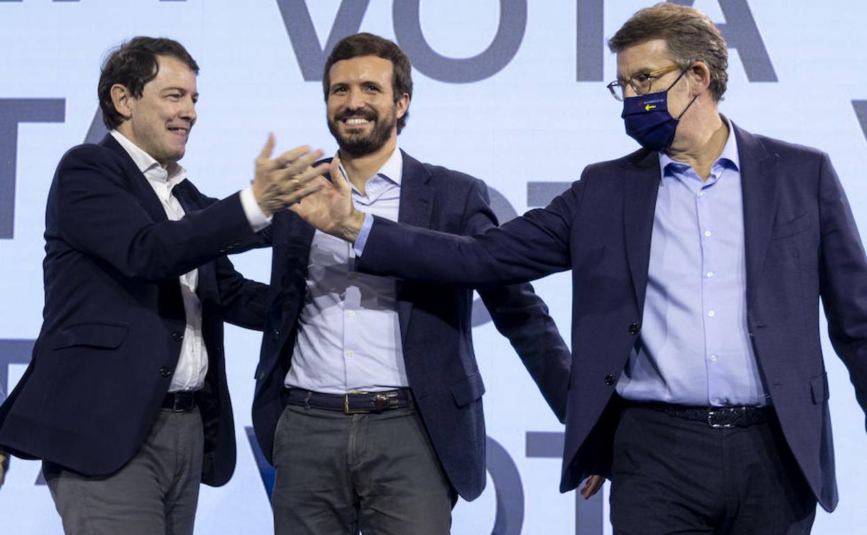 Alfonso Fernández Mañueco saluda a Alberto Núñez Feijóo en presencia de Pablo Casado, en el cierre de la campaña electoral en Valladolid. 