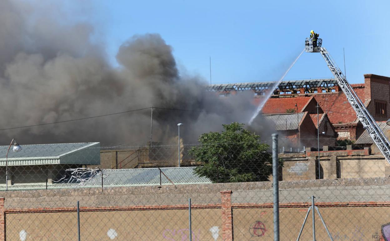 Los bomberos tratan de sofocar el incendio en la Fábrica de Armas de este jueves. 