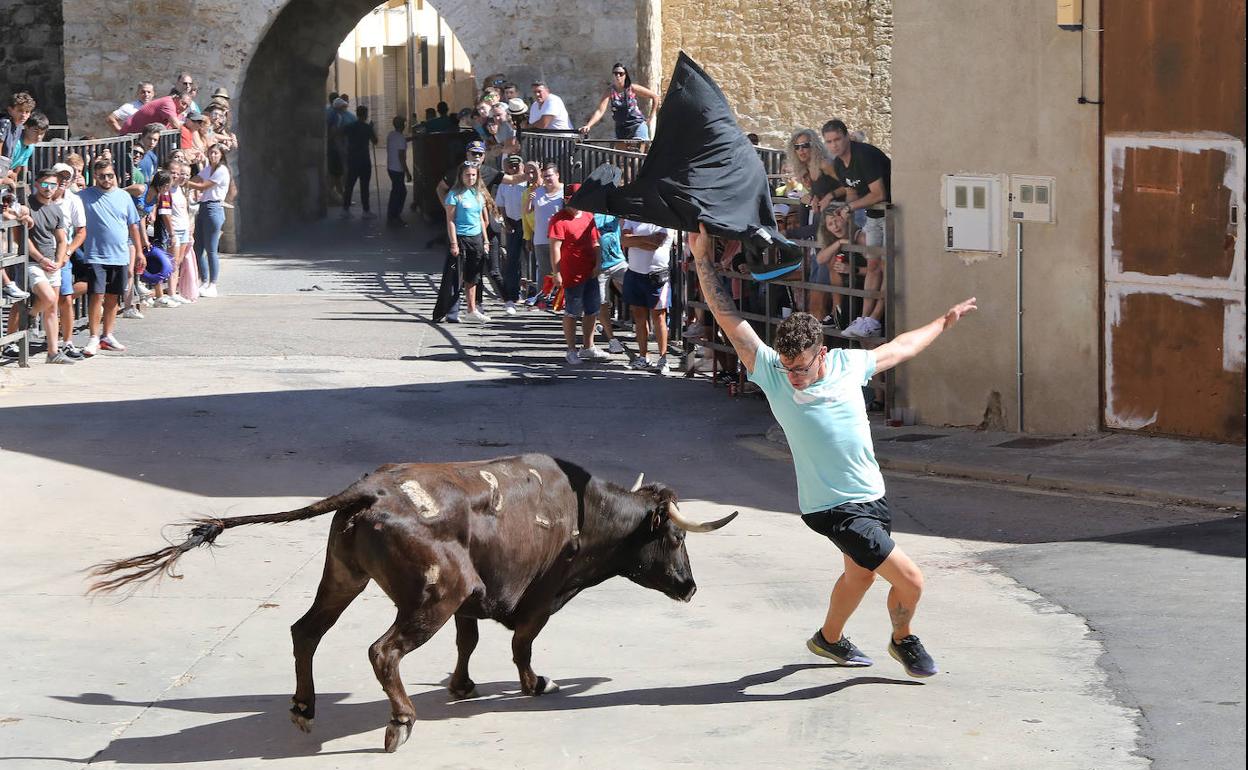 Un joven trata de esquivar a la vaquilla junto al Ojo de la Virgen.. 