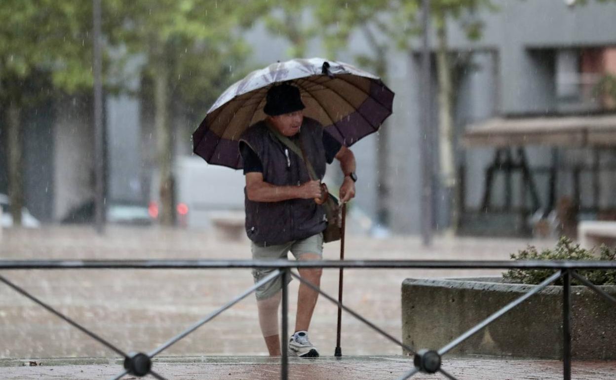 Un hombre se proteje de la tormenta en una imagen tomada a finales de agosto. 