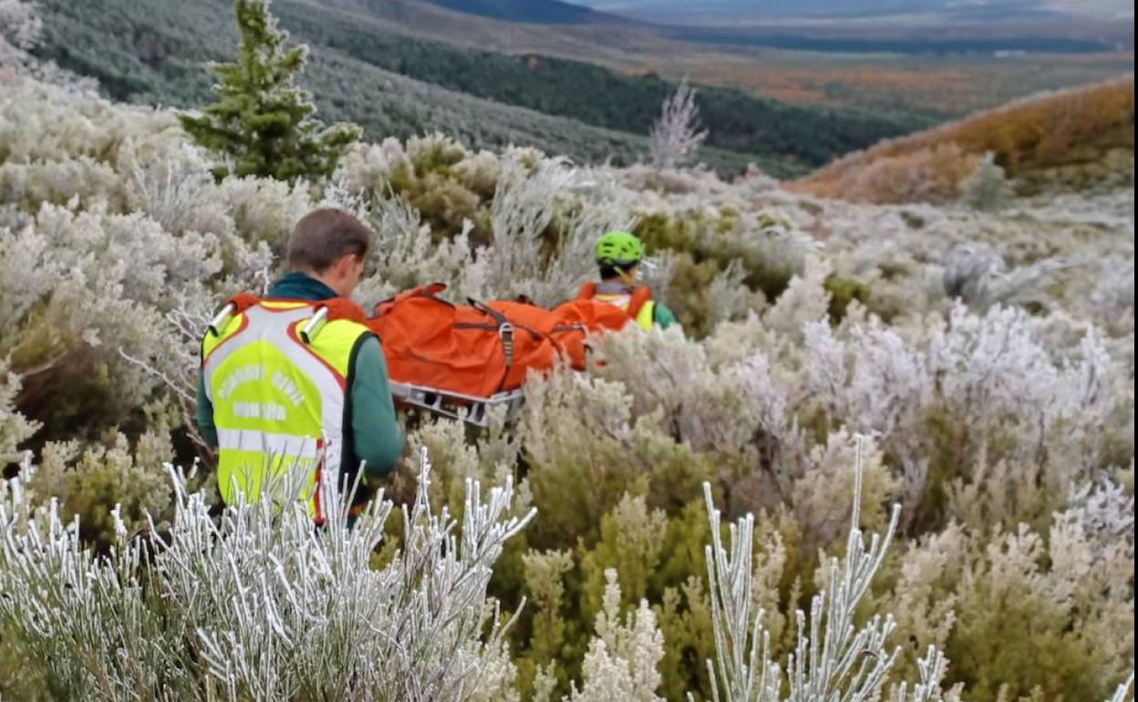 Agentes del grupo de rescate trasladan en camilla a la persona herida en el tobillo. 