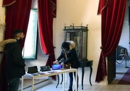 Trabajadores preparan las tabletas para comenzar un juego educativo en el Palacio Episcopal.